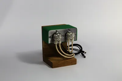 A pair of Coltiva peristaltic pumps mounted on an oak block, with dosing tubes running to the reservoir.