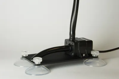 A Coltiva volume pump on a suction-cup mounting bracket.
